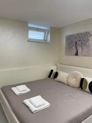 a bed in a room with two towels on it at VILA ROŽĖ Nakvynė in Raseiniai