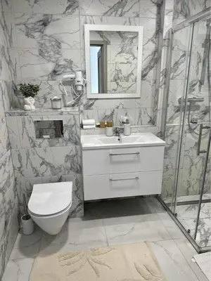 a bathroom with a toilet and a sink and a mirror at VILA ROŽĖ Nakvynė in Raseiniai