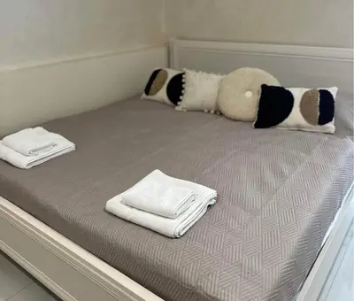 a bed with white towels and pillows on it at VILA ROŽĖ Nakvynė in Raseiniai