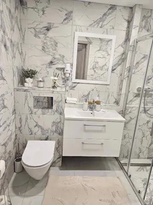 a bathroom with a toilet and a sink and a mirror at VILA ROŽĖ Nakvynė in Raseiniai