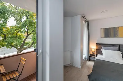 a bedroom with a bed and a window at RIVERFRONT 2BD Old Town Apartment by Domvia in Kaunas