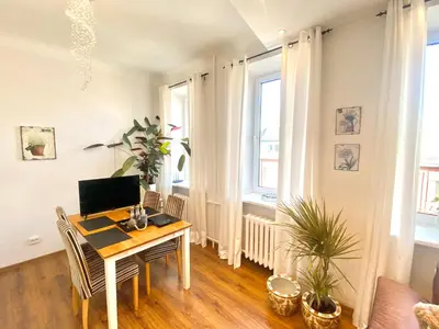 a room with a desk with a computer on it at City Central apartament in Šiauliai