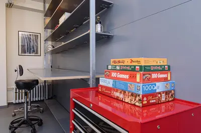 a stack of books sitting on top of a red table at Hidden Submarine in Vilnius