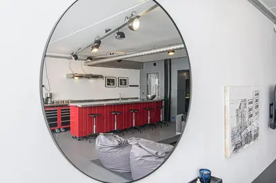 a mirror reflection of a kitchen with red cabinets at Hidden Submarine in Vilnius