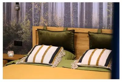 a bedroom with a bed with two pillows on it at Poilsio namelis in Skynimai