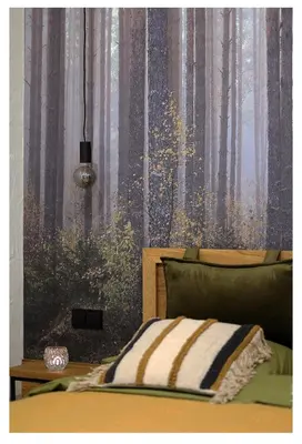 a bedroom with a bed with a forest wallpaper at Poilsio namelis in Skynimai