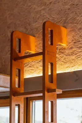 a pair of wooden beds in a room with a ceiling at Beautiful Tiny house on the lake side. in Trakai