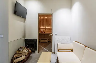 a living room with a tv and a fireplace at Pirties Spa namas in Molėtai