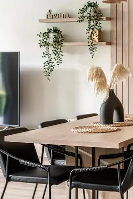 a dining room with a wooden table and chairs at Pirties Spa namas in Molėtai