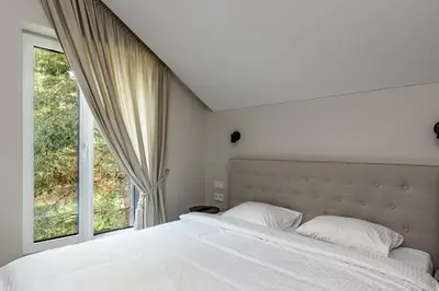 a bedroom with a large bed and a window at Pirties Spa namas in Molėtai