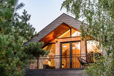 a house with a large window on a balcony at Pirties Spa namas in Molėtai