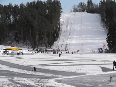 a group of people skiing down a snow covered slope at Svečių namai ALDAIVITA in Ignalina