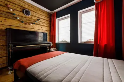 a bedroom with a bed and a piano at Apartments in Kaunas in Kaunas
