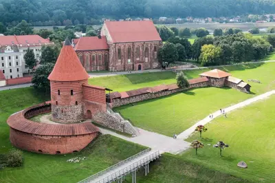 an aerial view of a large brick building in a park at Apartments in Kaunas in Kaunas