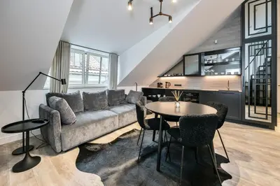 a living room with a couch and a table at Artsy Exclusive Old Town Residence Gallery Walk in Vilnius
