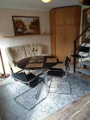a living room with a table and a couch at Namelis uždarame kieme in Šiauliai