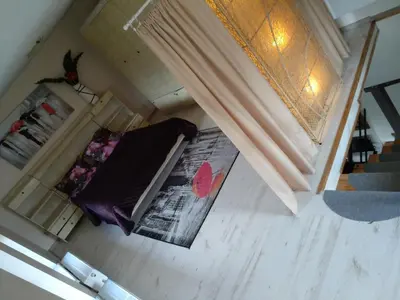 an overhead view of a room with a bed and a window at Namelis uždarame kieme in Šiauliai