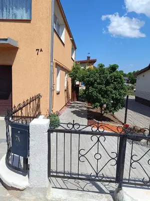 a black iron fence in front of a building at Namelis uždarame kieme in Šiauliai