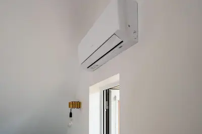 a white kitchen with a ceiling fan and a window at Vakaras cozy apartment in the guest house with the terrace and the stunning view to the river side in Birštonas