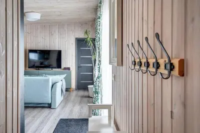 a living room with a blue couch and a tv at Bajorų sodyba in Padvarionys