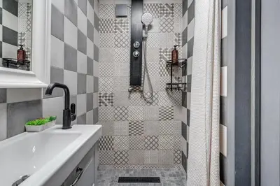 a bathroom with a shower with a white sink at Bajorų sodyba in Padvarionys