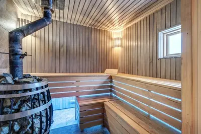 an empty wooden sauna with a large wooden boiler at Bajorų sodyba in Padvarionys