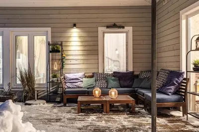 a porch with a couch and a coffee table at Bajorų sodyba in Padvarionys