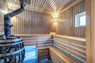 an empty wooden sauna with a large boiler at Bajorų sodyba in Padvarionys