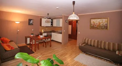 a living room with a couch and a table at Neravu namai in Druskininkai