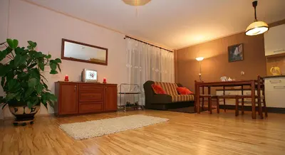a living room with a couch and a table at Neravu namai in Druskininkai