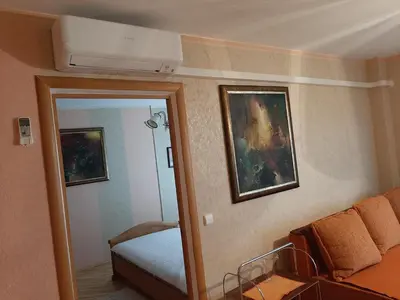 a room with a bed and a couch and a mirror at Neravu namai in Druskininkai