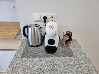 a coffee maker on a counter in a kitchen at Neris apartments in Šiauliai