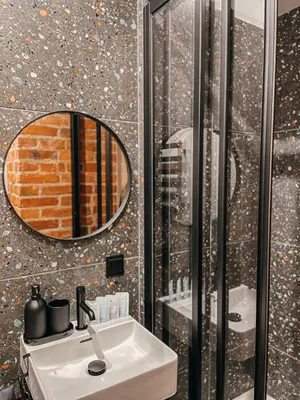 a bathroom with a sink and a mirror at 1880 Apartment with Private Parking in Marijampolė