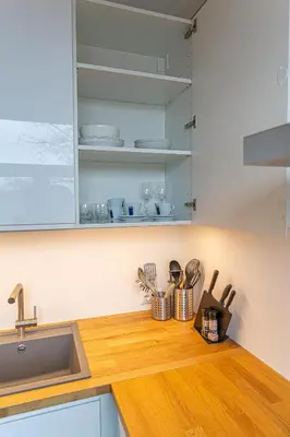a kitchen with a sink and a wooden counter top at Žalgiris arena apartment with AC in Kaunas
