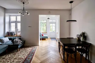 a living room with a table and a couch at NEW! WARM and COSY apartment with private ENTRANCE and PARKING in a city center in Vilnius