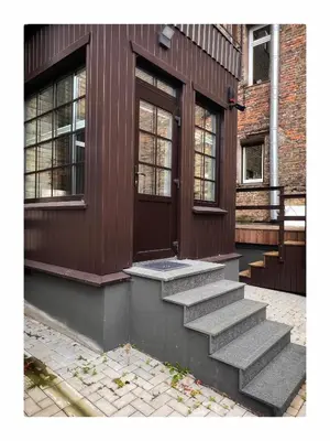 a building with a door and stairs in front of it at NEW! WARM and COSY apartment with private ENTRANCE and PARKING in a city center in Vilnius