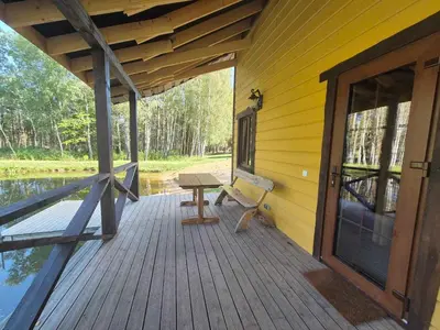 a porch of a house with a bench on it at Bona Natura Pirtelė in GratiÅ¡kÄ—s