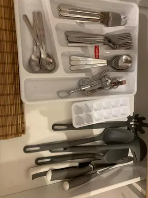a drawer full of utensils in a refrigerator at New Ozas flat in Vilnius