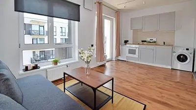 a living room with a couch and a table at New Ozas flat in Vilnius
