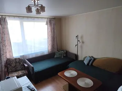 a living room with a couch and a chair at ITAJA apartment in Šiauliai
