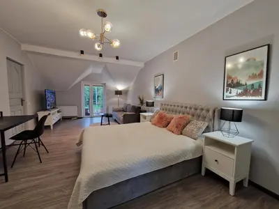a bedroom with a bed and a living room at Seliu 25 Homestay Apartment poilsio namai in Šiauliai
