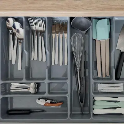 a plastic container with utensils in a drawer at Seliu 25 Homestay Apartment poilsio namai in Šiauliai