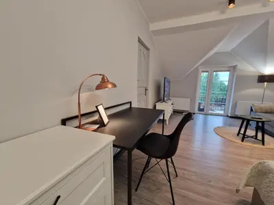 a kitchen and living room with a table and chairs at Seliu 25 Homestay Apartment poilsio namai in Šiauliai