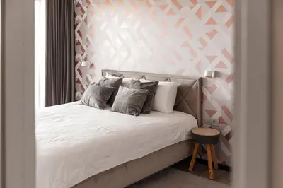 a bed with white sheets and pillows in a room at Bright Kaunas apartment with Castle view in Kaunas