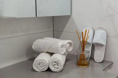 a pile of towels on a counter in a bathroom at Bright Kaunas apartment with Castle view in Kaunas