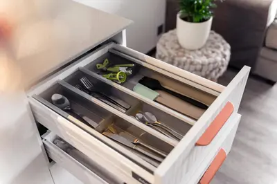 a drawer in a kitchen withrenches and other kitchen utensils at Bright Kaunas apartment with Castle view in Kaunas