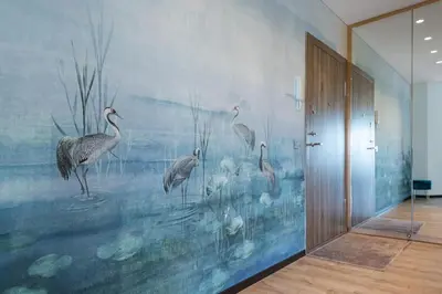a room with a mural of birds on the wall at Bright Kaunas apartment with Castle view in Kaunas