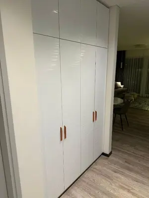a white closet with white cabinets in a room at Bright Kaunas apartment with Castle view in Kaunas