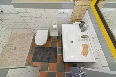 a bathroom with a sink and a toilet at Modern Vilnius Old Town apartment with free parking in Vilnius