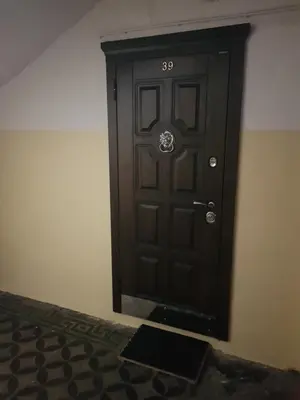 a black door in a corner of a room at Modern Vilnius Old Town apartment with free parking in Vilnius